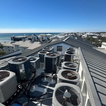Rows of rooftop condensers with beach and Gulf view — Affordable Air Service