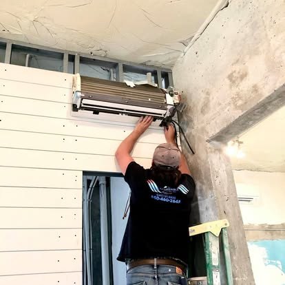 Technician installing a wall-mounted mini-split head — Affordable Air Service